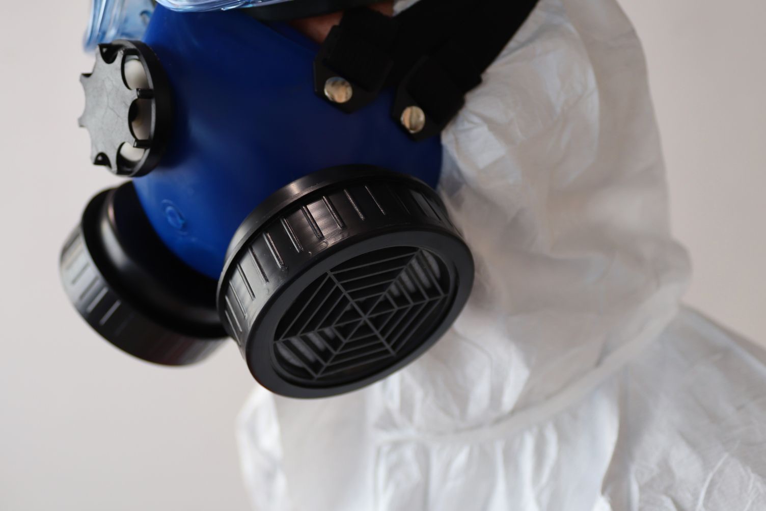A technician in protective gear during mold remediation